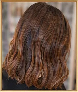 Capelli color rame lunghi fino alle spalle, con le punte mosse, visti da dietro.